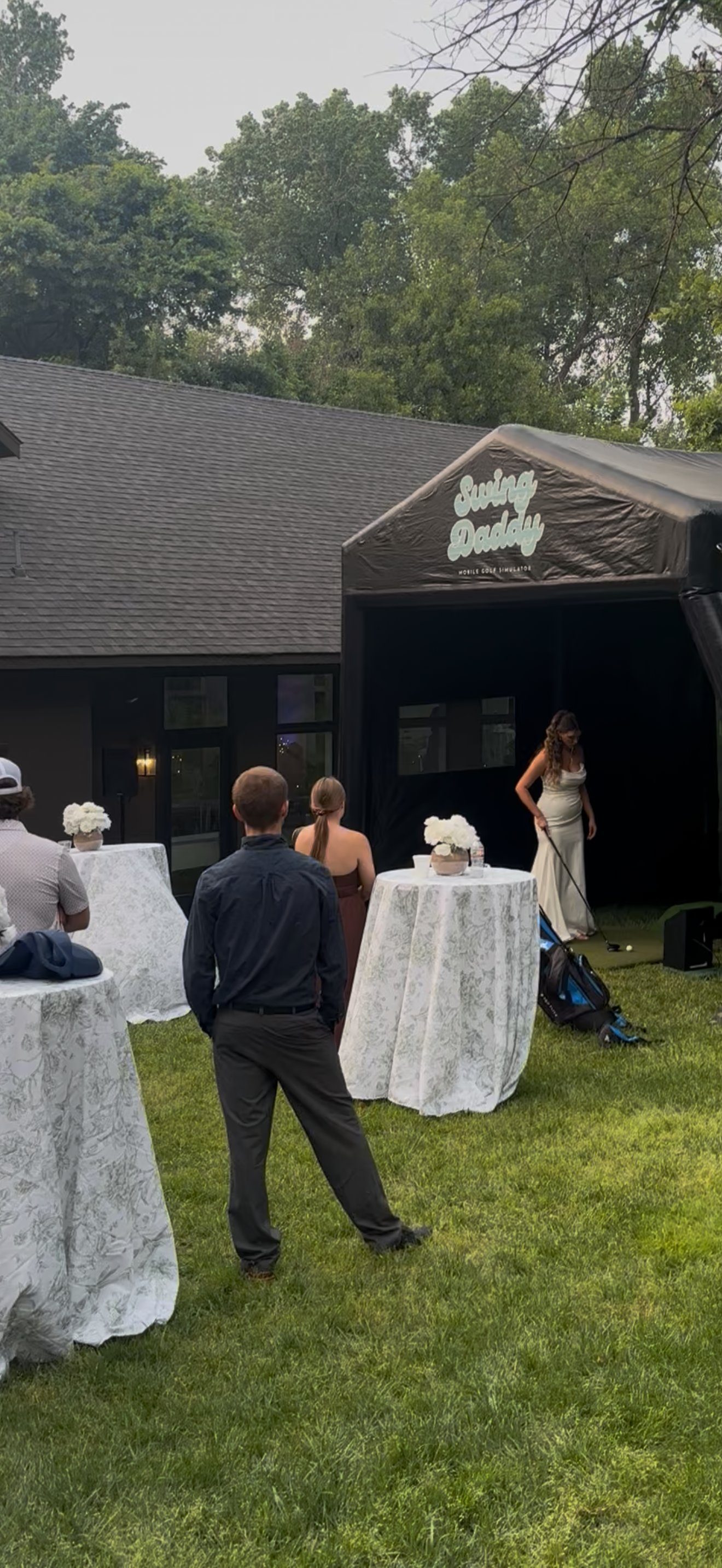 Bride enjoying the Swing Daddy mobile golf simulator at an Oklahoma wedding