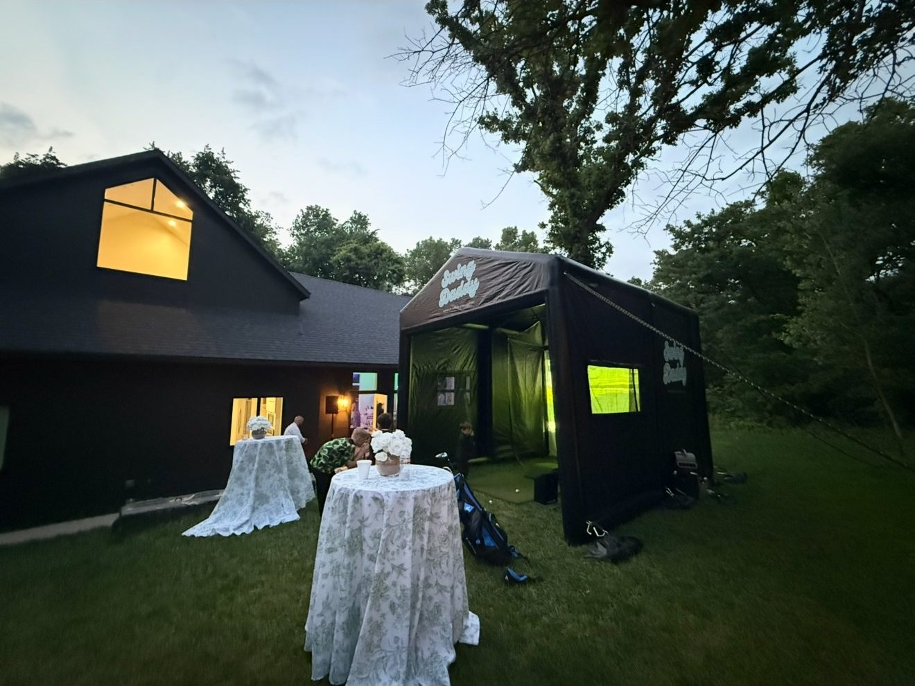Swing Daddy mobile golf simulator glowing at an evening wedding reception in Oklahoma
